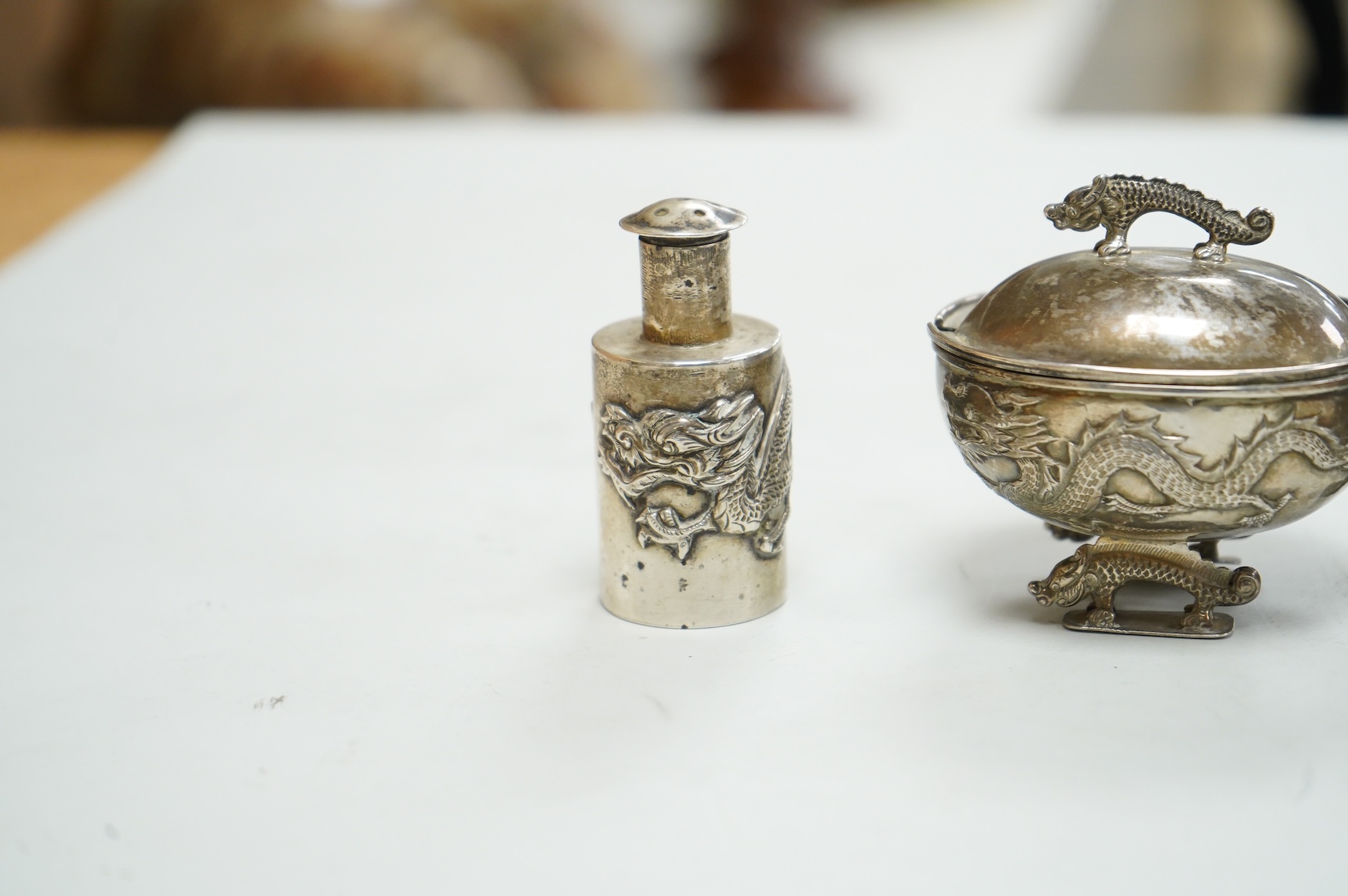 Three early 20th century Chinese export white metal condiments including a drum mustard pot and pepperette by Wang Hing, Hong Kong, pepperette 63mm.